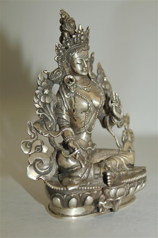 An unusual Tibetan silver seated figure of Green Tara, possibly 19th century, 11.7cm